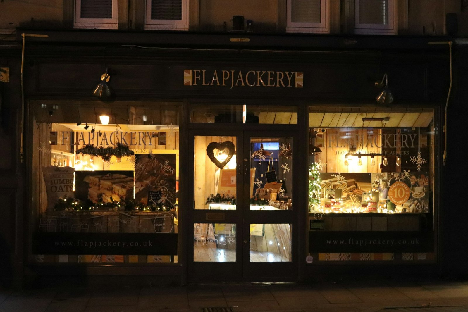 Small shop front lit up at night