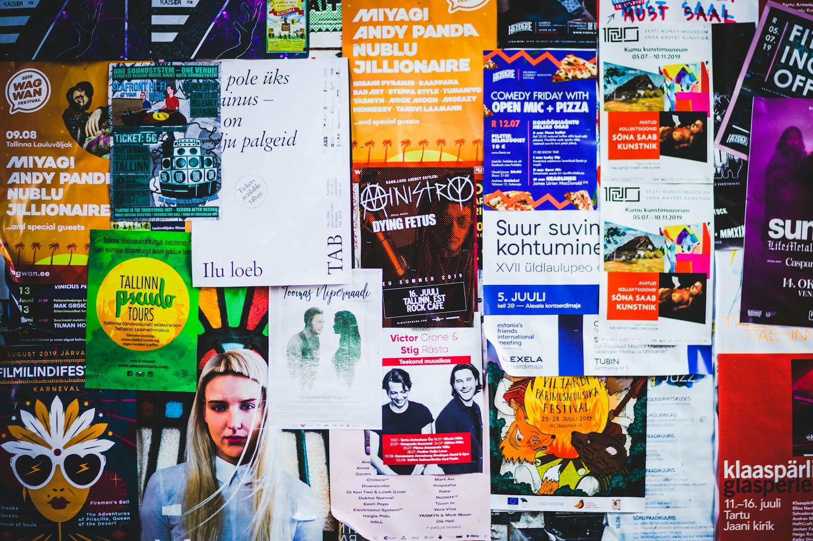 Wall of printed advertising posters