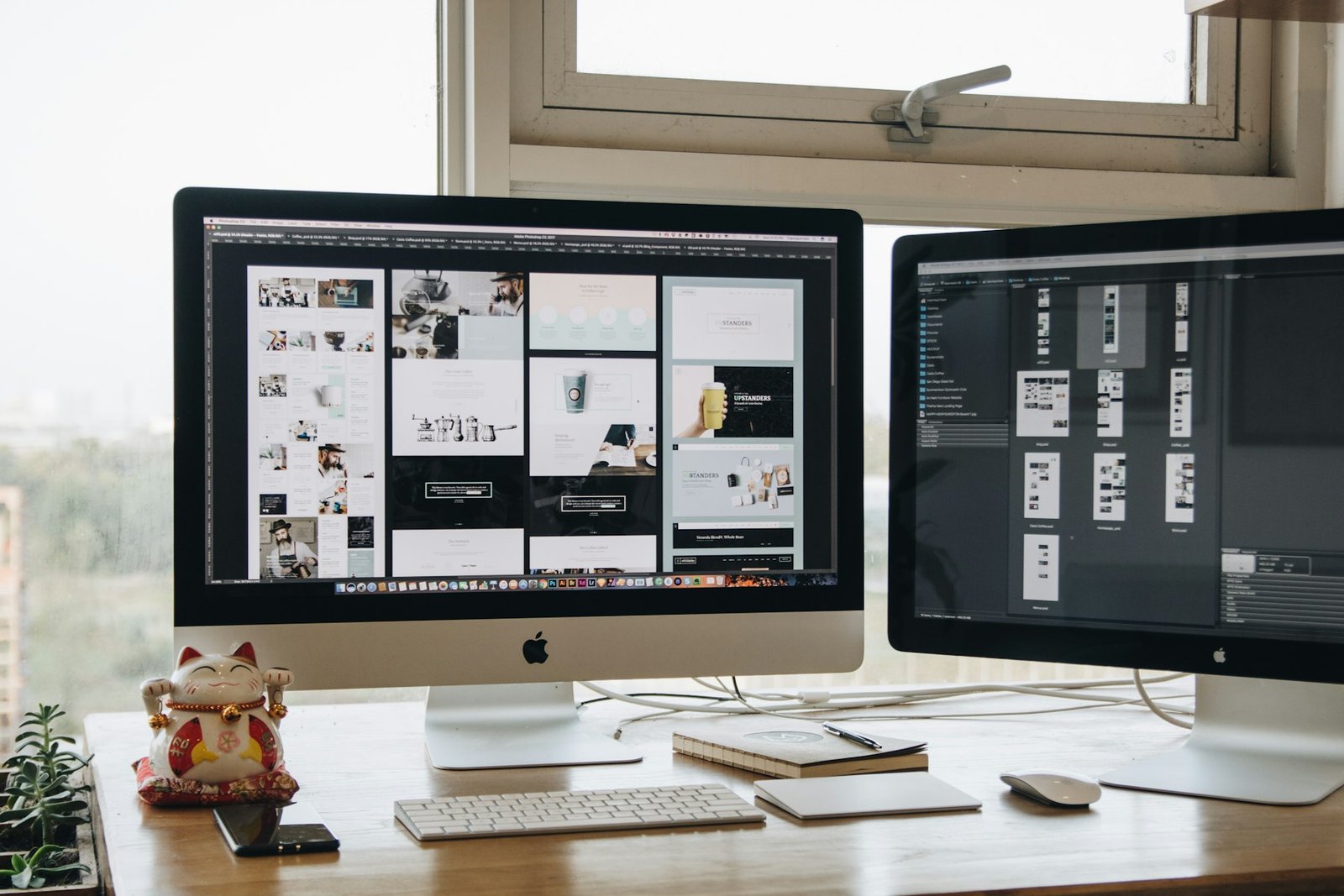 Design workstation with two monitors showing website layouts