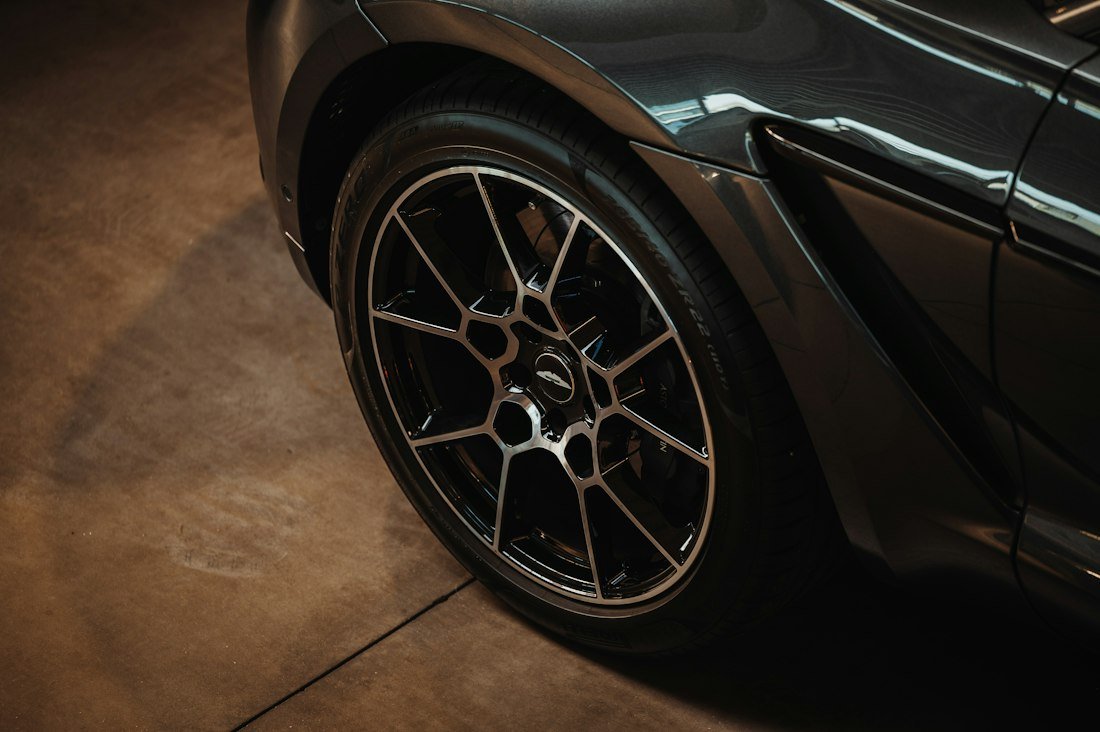 A black sports car parked in a garage