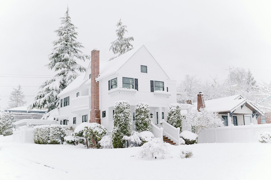 Houses covered with snow during daytime