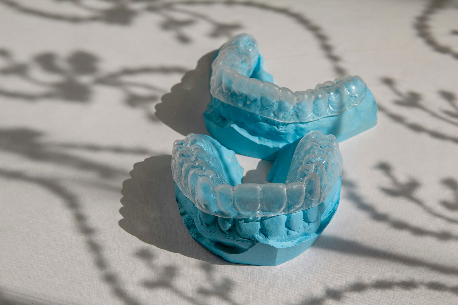 Clear dental aligners on a light surface