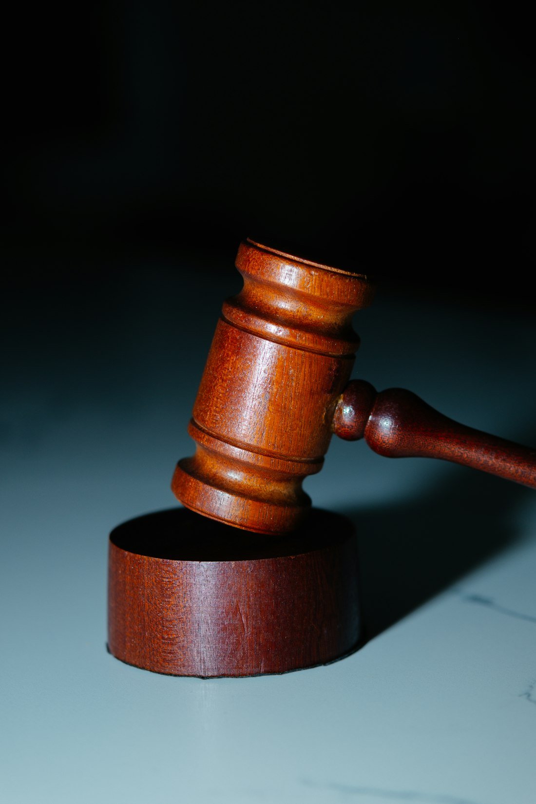 A wooden judge's hammer on top of a table