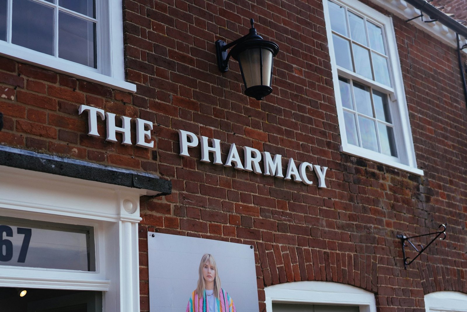 The pharmacy sign on a brick building