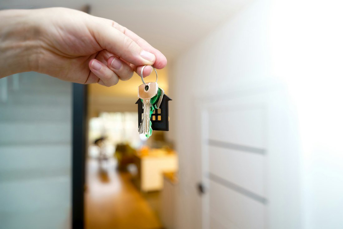 House keys held in front of a front door