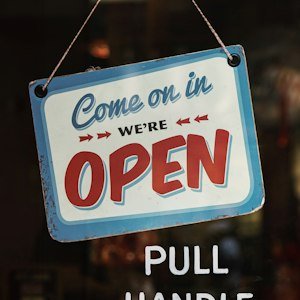 Open for business sign in a shop window