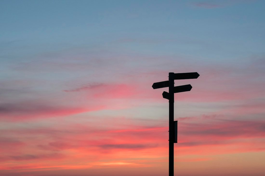 Silhouette of road signage during golden hour