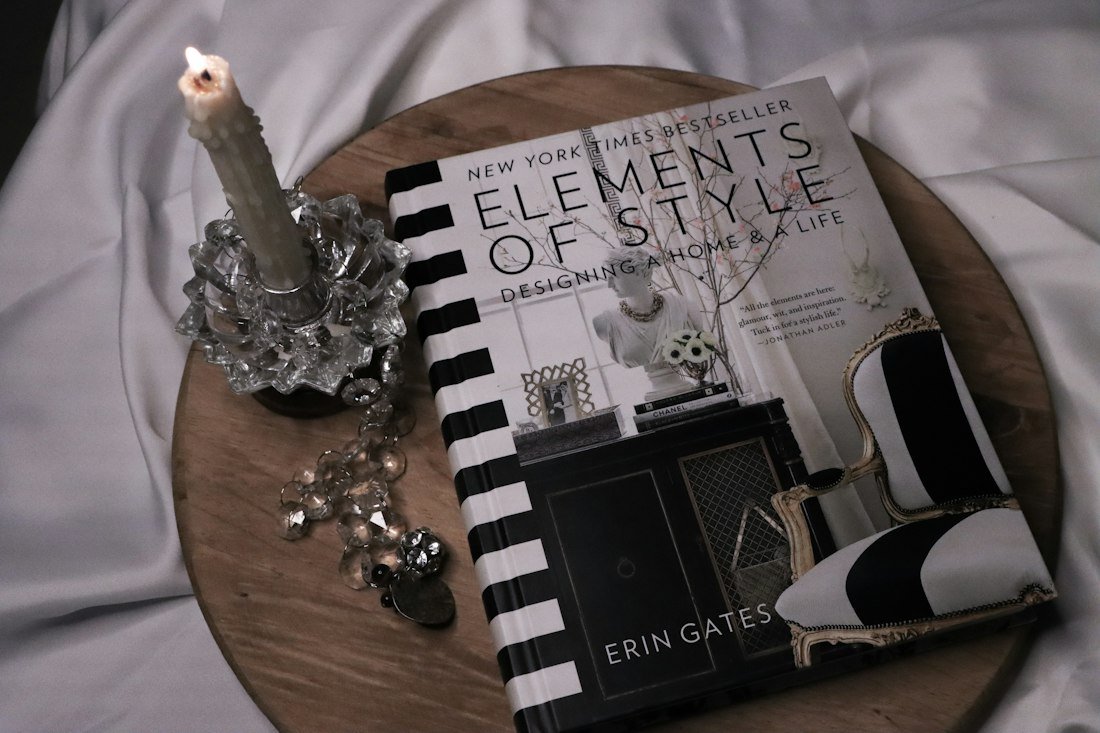 A book and a key chain on a bed