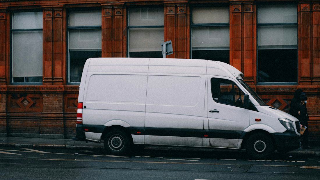 A white van parked on the side of the road