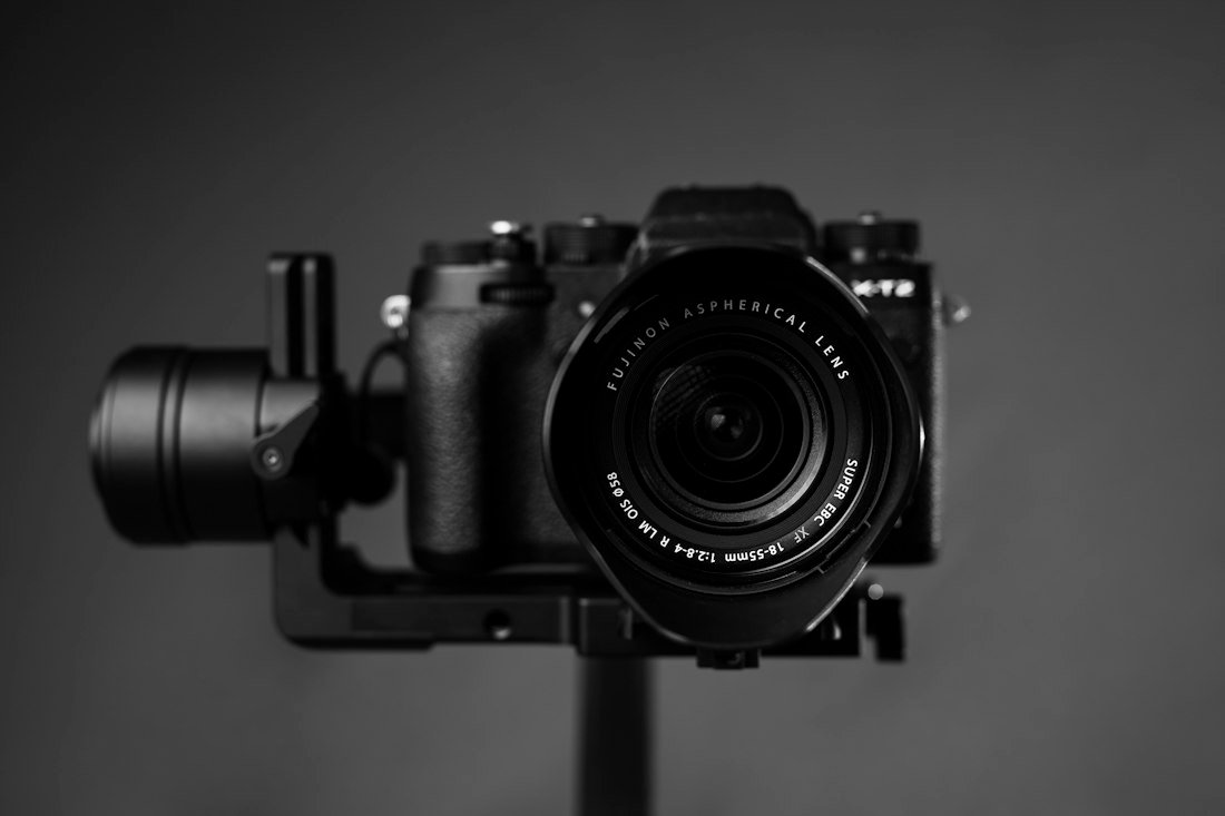 Black nikon dslr camera on brown wooden table
