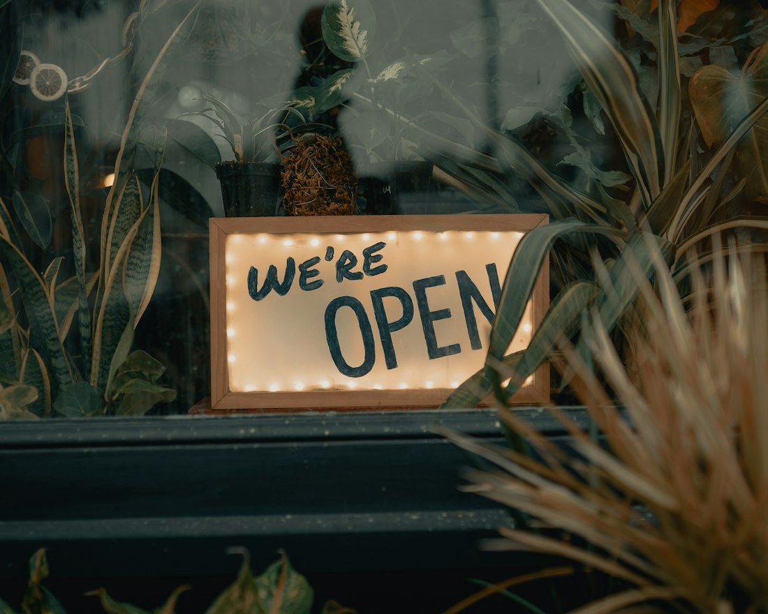 Illuminated we're open sign in a shop window