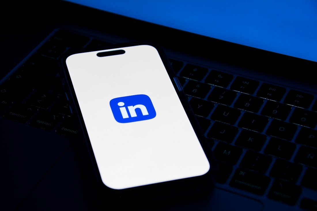 A phone sitting on top of a laptop computer