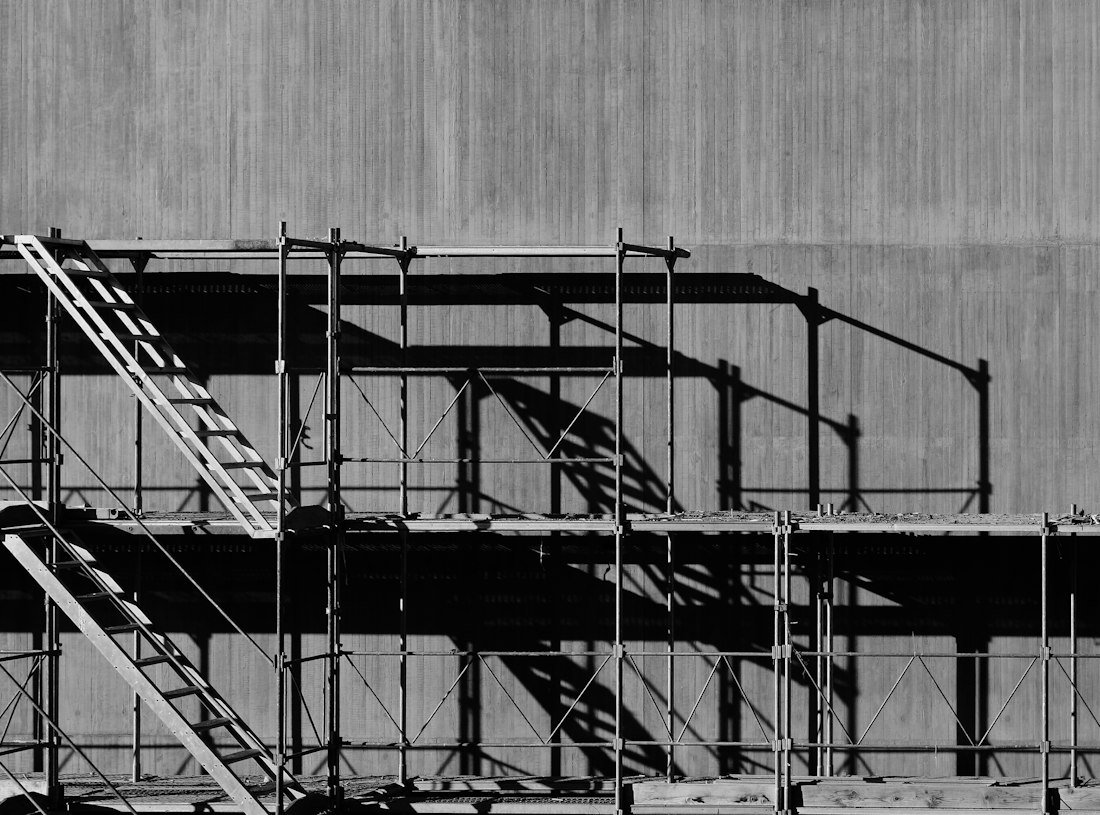 Grayscale photography of piled racks